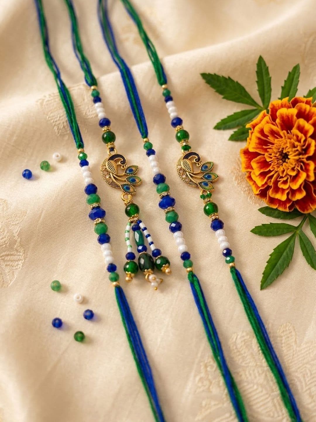 NVR Set Of 4 Green Peacock Design Artificial Beads Thread Rakhi With Roli Chawal - view 1